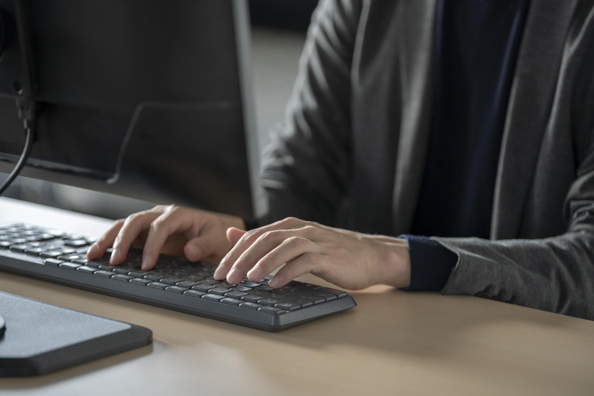 パソコンのキーボードを入力している人の手元アップ